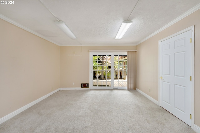 spare room with crown molding, light colored carpet, and a textured ceiling