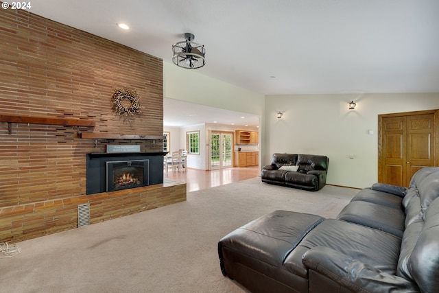 living room featuring light colored carpet and vaulted ceiling