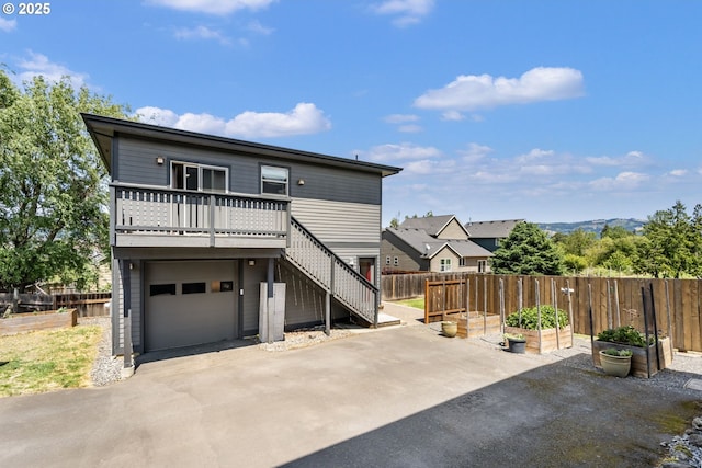 1105 29th St, Hood River, OR 97031 - back of property with a garden, driveway, stairs, and an attached garage