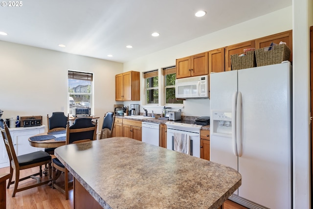1105 29th St, Hood River, OR 97031 - kitchen featuring white appliances, recessed lighting, light wood-style flooring, a sink, and a kitchen island