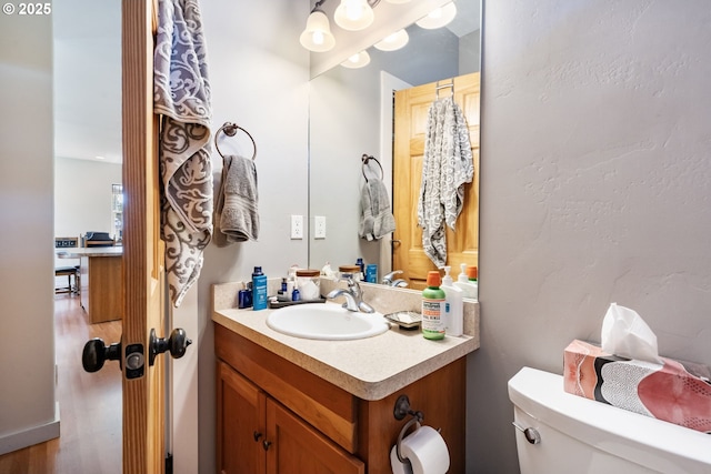 1105 29th St, Hood River, OR 97031 - half bath with vanity, toilet, and wood finished floors
