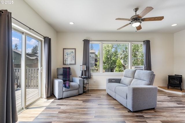 1105 29th St, Hood River, OR 97031 - sitting room featuring a wood stove, wood finished floors, ceiling fan, recessed lighting, and baseboards