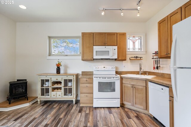 1105 29th St, Hood River, OR 97031 - kitchen with white appliances, a sink, a wood stove, dark wood-type flooring, and rail lighting