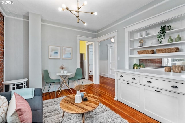 living area with an inviting chandelier and light hardwood / wood-style floors