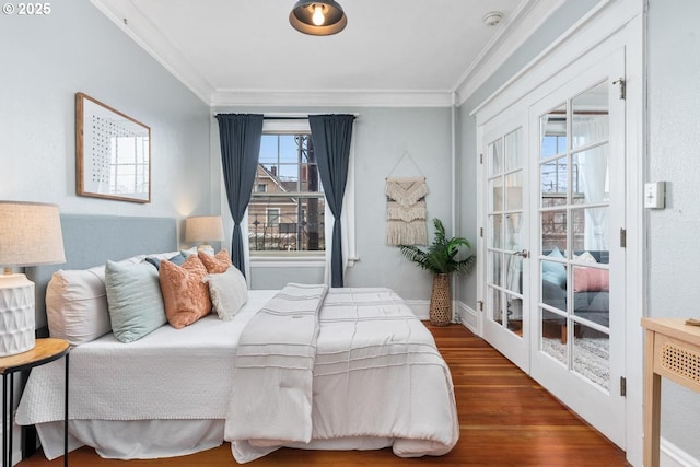 bedroom with ornamental molding and dark hardwood / wood-style floors