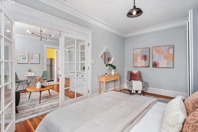 bedroom with french doors, stainless steel fridge, crown molding, and hardwood / wood-style flooring