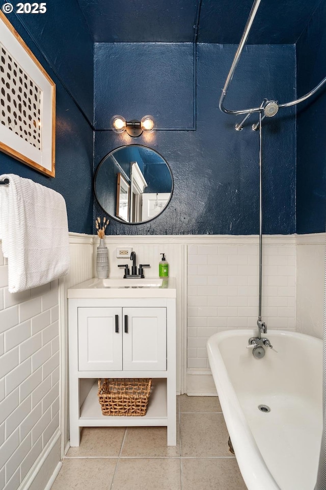 bathroom with tile patterned flooring, vanity, and shower / washtub combination