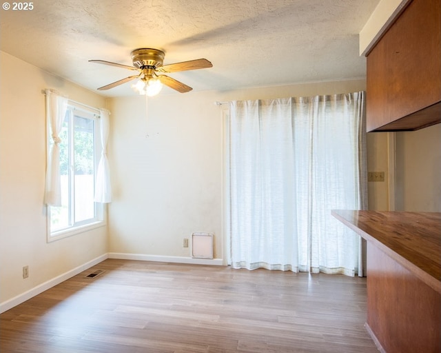 4631 Daisy St, Springfield, OR 97478 - spare room with wood finished floors, a ceiling fan, and a textured ceiling
