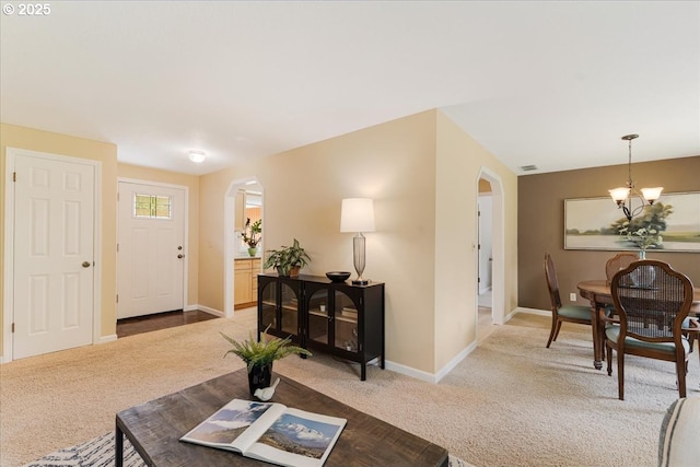 8740 SW Bomar Ct, Portland, OR 97223 - living room featuring arched walkways, carpet flooring, and baseboards