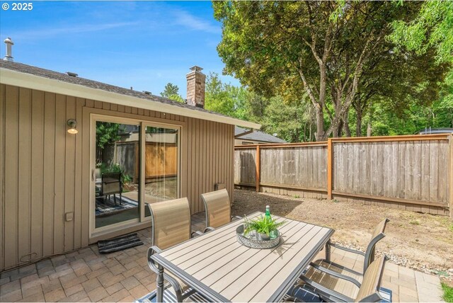 8740 SW Bomar Ct, Portland, OR 97223 - fenced backyard with a patio and outdoor dining space