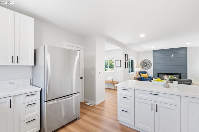 kitchen featuring freestanding refrigerator, open floor plan, light wood-type flooring, and recessed lighting