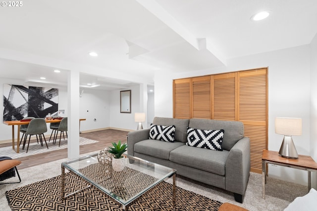 living area featuring wood finished floors, baseboards, and recessed lighting