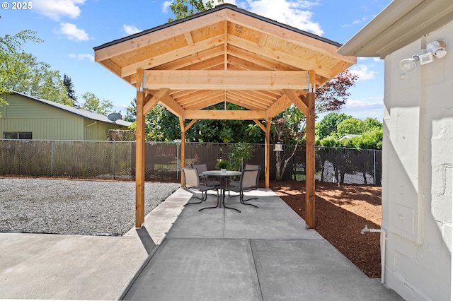 view of patio featuring outdoor dining space, a gazebo, and a fenced backyard