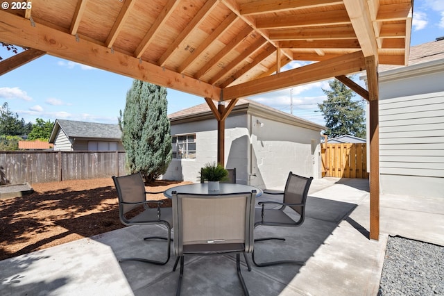 view of patio with a fenced backyard and outdoor dining area