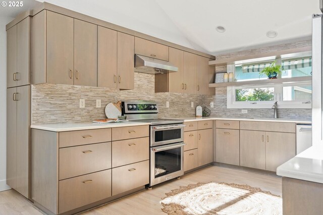 16448 NW Mcnamee Rd, Portland, OR 97231 - kitchen featuring under cabinet range hood, range with two ovens, light countertops, tasteful backsplash, and light wood-type flooring