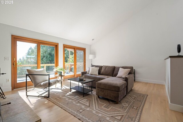 16448 NW Mcnamee Rd, Portland, OR 97231 - living room featuring light wood-style flooring, baseboards, and high vaulted ceiling