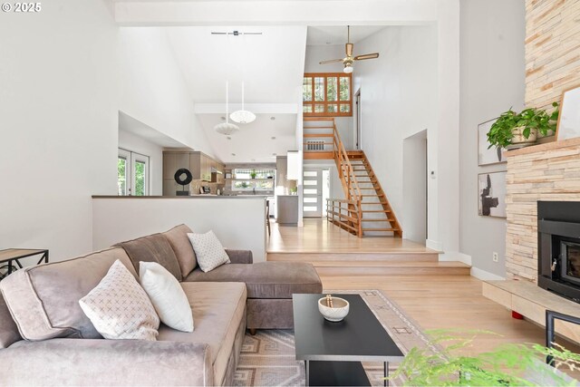 16448 NW Mcnamee Rd, Portland, OR 97231 - living room with high vaulted ceiling, stairs, wood finished floors, ceiling fan, and baseboards