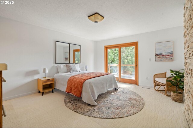 16448 NW Mcnamee Rd, Portland, OR 97231 - bedroom with access to outside, baseboards, carpet flooring, and a textured ceiling