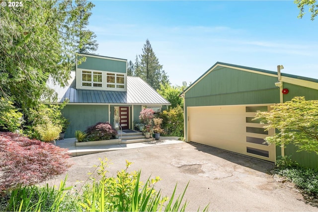 16448 NW Mcnamee Rd, Portland, OR 97231 - mid-century inspired home featuring metal roof, a garage, and asphalt driveway