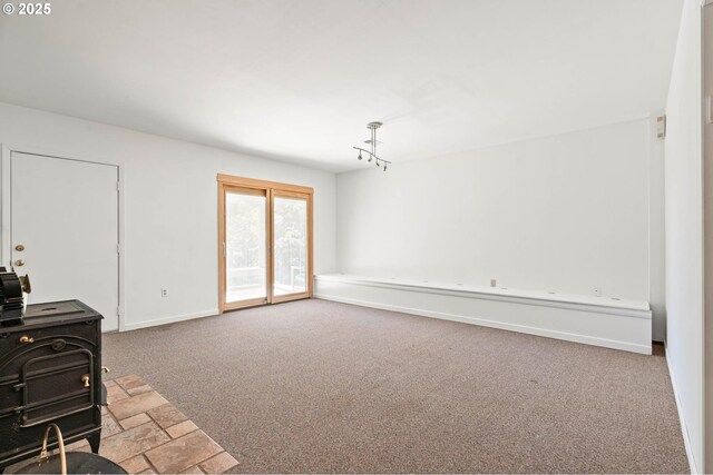 16448 NW Mcnamee Rd, Portland, OR 97231 - unfurnished living room with carpet floors and baseboards