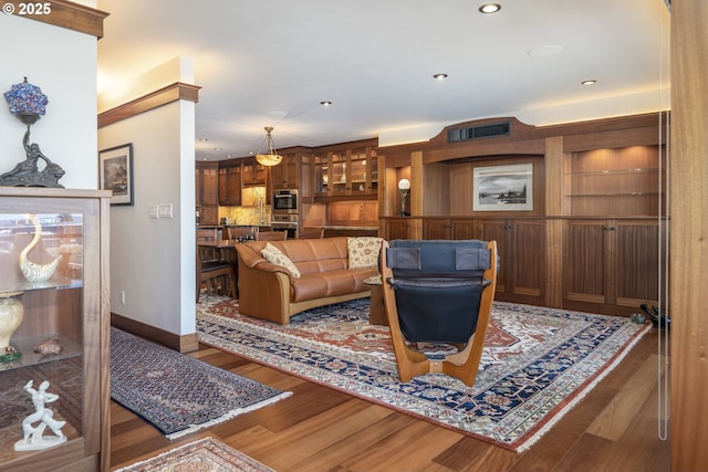 1 3rd St Unit 501, Astoria, OR 97103 - living room featuring wood finished floors, baseboards, and recessed lighting