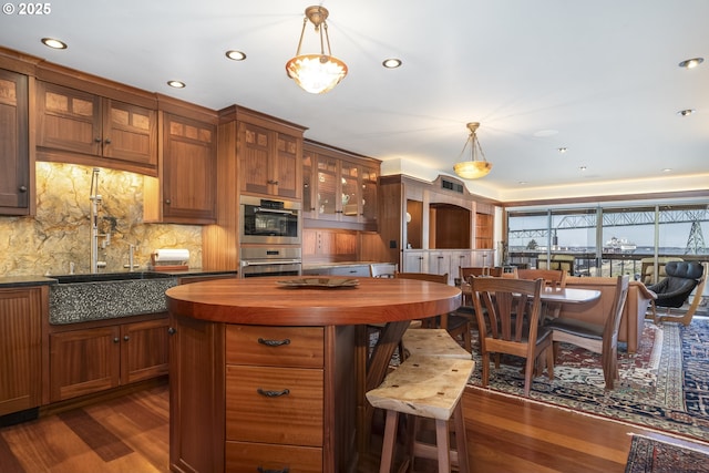 1 3rd St Unit 501, Astoria, OR 97103 - kitchen featuring butcher block countertops, dark wood finished floors, double oven, brown cabinetry, and recessed lighting