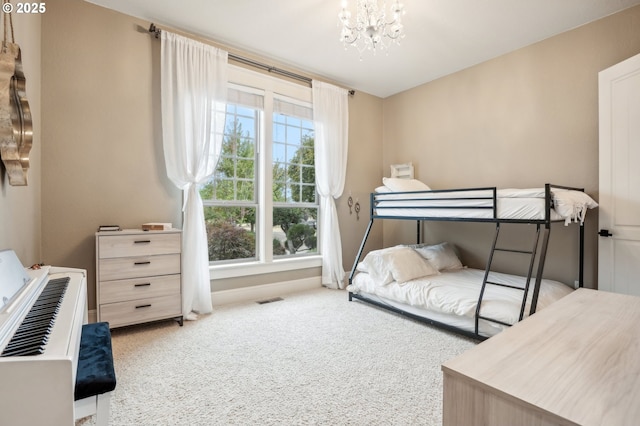 bedroom featuring carpet, a chandelier, and baseboards