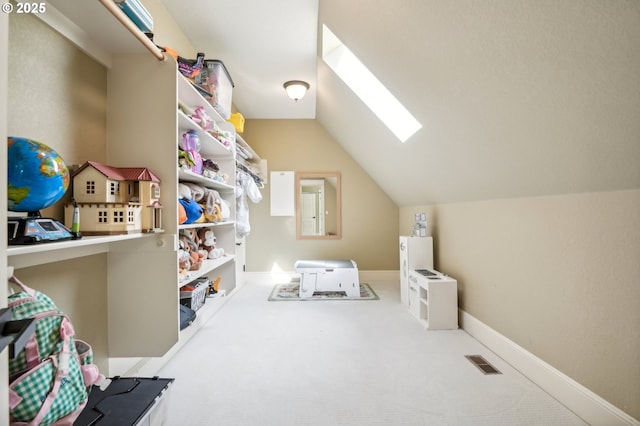 bonus room with a skylight, vaulted ceiling, carpet floors, and baseboards