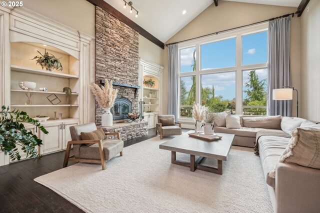 living area featuring high vaulted ceiling, a fireplace, dark wood finished floors, and built in features