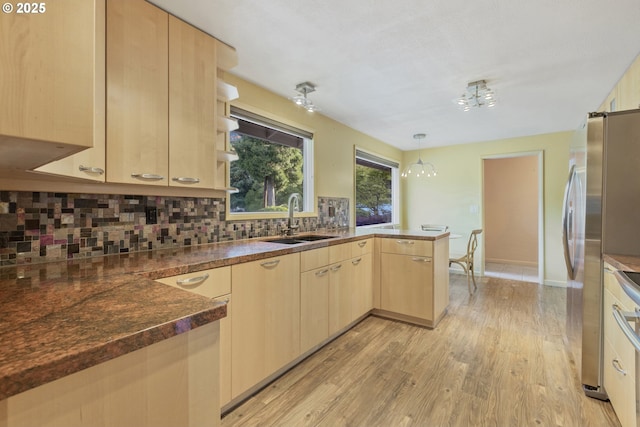 2691 Country Ln, Eugene, OR 97401 - kitchen featuring light brown cabinets, a peninsula, decorative backsplash, and light wood-style floors