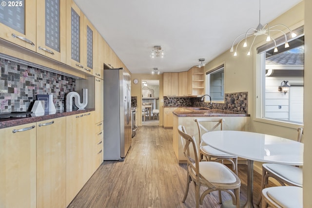 2691 Country Ln, Eugene, OR 97401 - kitchen with freestanding refrigerator, light brown cabinets, dark countertops, light wood-style flooring, and open shelves