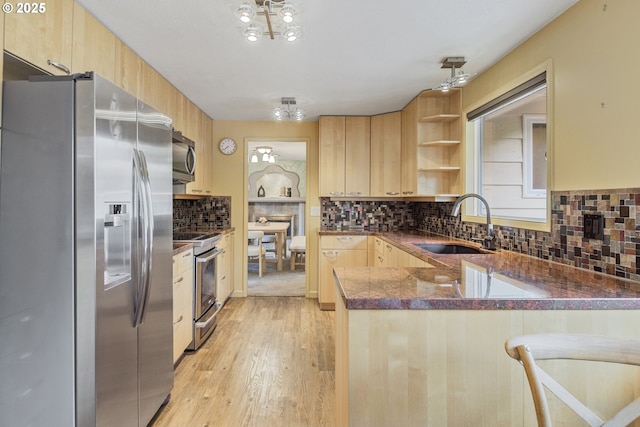 2691 Country Ln, Eugene, OR 97401 - kitchen with appliances with stainless steel finishes, light brown cabinets, and a peninsula