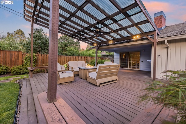 2691 Country Ln, Eugene, OR 97401 - deck at dusk with an outdoor living space with a fire pit, a pergola, a fenced backyard, and ceiling fan