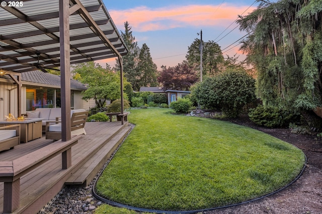 2691 Country Ln, Eugene, OR 97401 - yard at dusk with ceiling fan, a wooden deck, a lawn, and a pergola