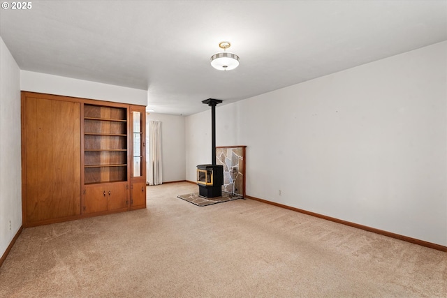 1550 Ash St, Baker City, OR 97814 - unfurnished living room with a wood stove, light carpet, and baseboards