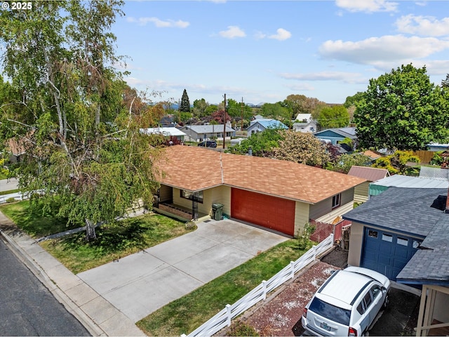 1550 Ash St, Baker City, OR 97814 - view of front of house with an attached garage, a residential view, roof with shingles, and concrete driveway