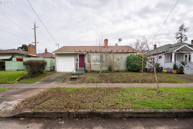 view of front of property featuring an attached garage, a chimney, and concrete driveway