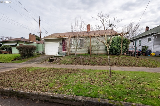 ranch-style house featuring driveway, a front lawn, and an attached garage