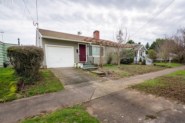 single story home featuring an attached garage, driveway, and a chimney