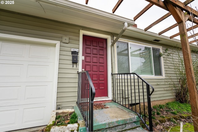 property entrance featuring an attached garage