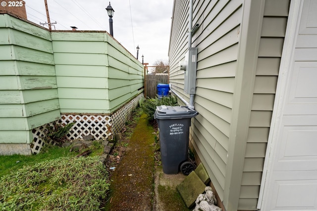 view of side of property featuring fence