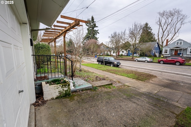 exterior space with a residential view and a pergola