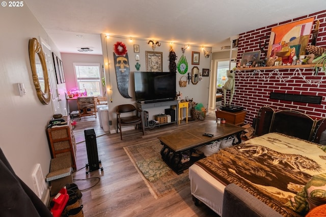 living room with a fireplace and wood finished floors