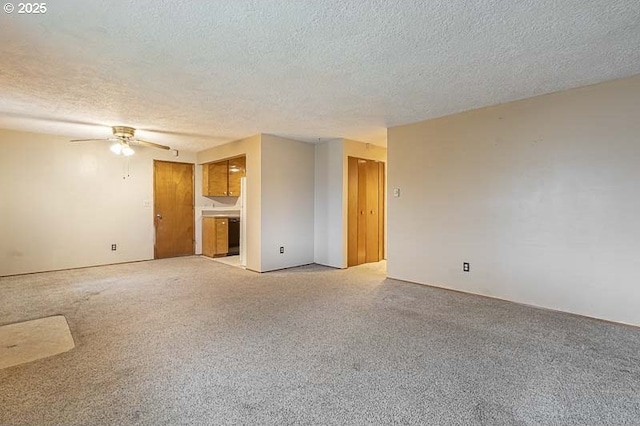 unfurnished living room with light carpet, a textured ceiling, and a ceiling fan