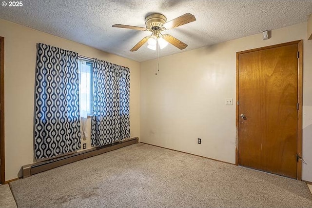 spare room featuring a baseboard radiator, carpet, a ceiling fan, and a textured ceiling