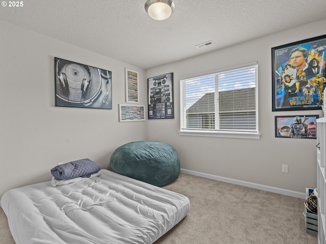 sitting room with visible vents, baseboards, a textured ceiling, and carpet flooring