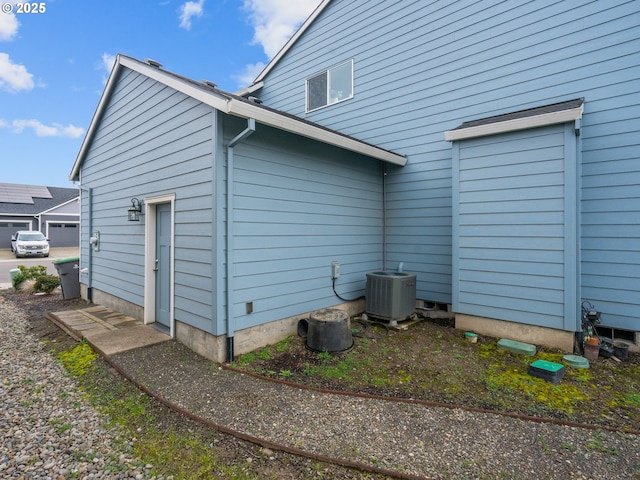 view of side of home with central air condition unit