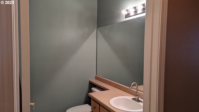 half bathroom with toilet and vanity