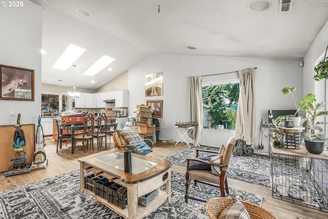 731 SE Forest Glen Rd, Estacada, OR 97023 - living area featuring a skylight, plenty of natural light, light wood finished floors, and high vaulted ceiling