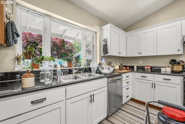 731 SE Forest Glen Rd, Estacada, OR 97023 - kitchen featuring stainless steel dishwasher, a sink, vaulted ceiling, white cabinets, and dark countertops